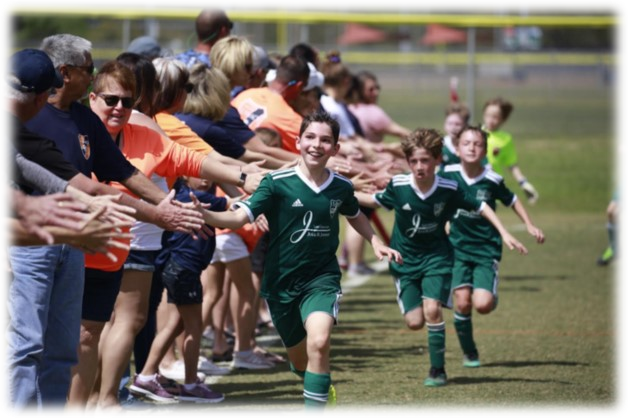 10U MYB players running through parent high 5's after a game